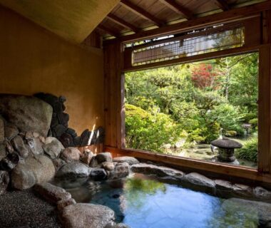 Stone onsen bath facing lush Japanese garden at Kakureisen in Saga, Kyūshū
