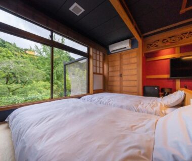 Futon bedding in tatami room overlooking lush garden at Kakureisen in Saga, Kyushu, Japan