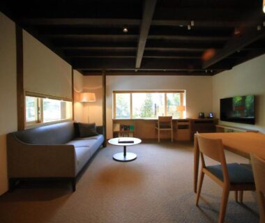 Sofa and low table living area with desk and TV at Kamakura COCON, Kanagawa
