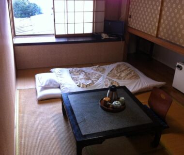 Tatami room with futon, low table, shoji screens and window seat, Kamesei Ryokan Nagano