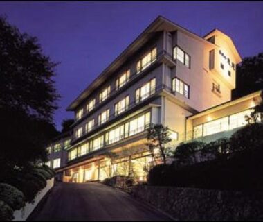 Lit multi-story ryokan exterior at dusk, Kameya Ean in Shizuoka, Chūbu region