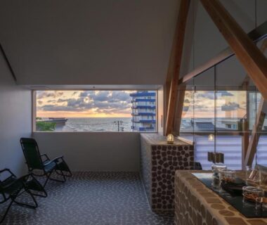 Open rooftop seating with wooden beams, tiled counter and city view at Kameya Hotel in Yamagata