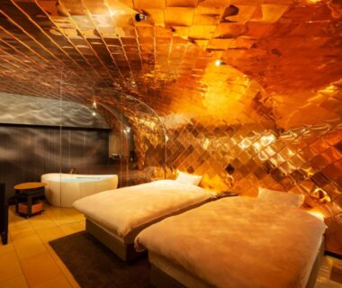 Warm gold mosaic interior with two low beds at Kameya Hotel, Yamagata, Tōhoku, Japan