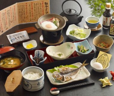 Traditional Japanese breakfast spread with grilled fish, rice, miso soup, side dishes and tea at Kameyama Onsen Hotel, Chiba