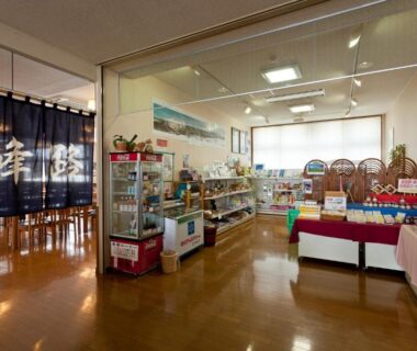 Interior gift shop with wooden floors, product displays and noren at Kamihoroso Hokkaido