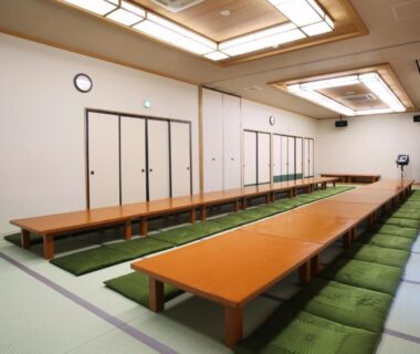 Long tatami dining hall with low tables and floor cushions at Kamihoroso, Hokkaido, Japan
