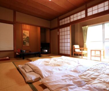 Traditional tatami room with laid futon and shoji screens at Kamiobo, Hyōgo, Kansai