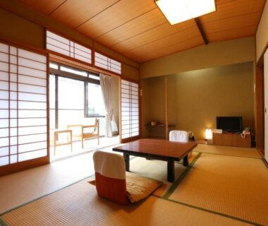 Traditional tatami room with low table and shoji screens at Kamiobo in Hyōgo, Kansai