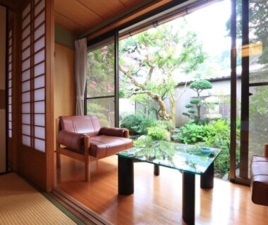 Traditional tatami room with shoji screens, low table and garden view at Kamiobo in Hyōgo, Kansai