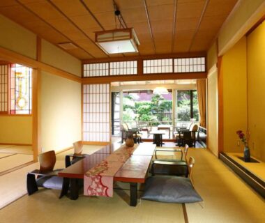 Tatami dining area with shoji screens and garden view at Kamiyamada Hotel, Nagano, Chūbu Japan