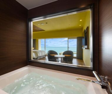 Bathtub in guest room overlooking seating area at Kamogawa Grand Hotel in Chiba