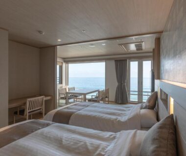 Twin beds with balcony overlooking the sea at Kamogawa Grand Hotel in Chiba Kanto