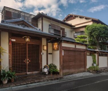 Wooden lattice entrance with potted plants at Kamuroan in Kyoto, Kansai