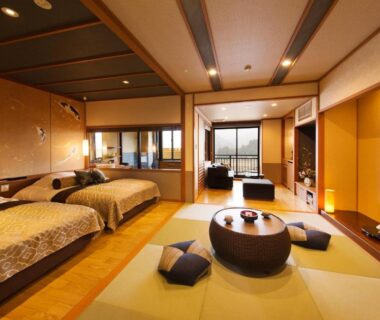 Spacious tatami room with twin beds, low table, shoji screens and balcony at Kanazawa Hyakurakusou, Ishikawa