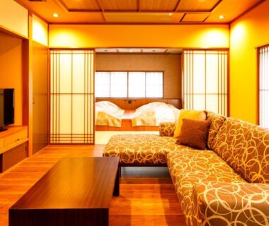 Room with sofa, low wooden table and shoji screens at Kanazawa Yuwaku Onsen Kokarian, Ishikawa Japan