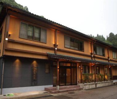 Exterior of Kanazawa Yuwaku Onsen Kokarian with warm lantern lighting and entrance in Ishikawa
