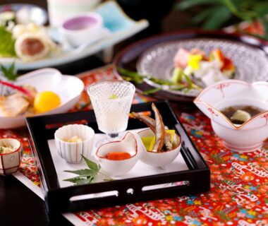 Assorted traditional Japanese small dishes on lacquer tray at Kanko Hotel Tamaru Nara ryokan dining
