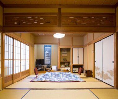 Traditional tatami room with kotatsu, shoji screens and tokonoma at Kanko Ryokan Kuboji in Nara
