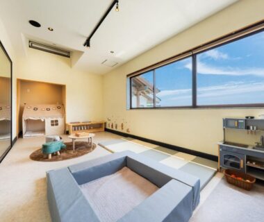 Bright tatami room with low table, recessed seating and large window at Kannawaen in Ōita, Kyushu, Japan