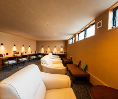 Cream lounge sofas, wooden tables and desk lamps at Kannawaen in Oita, Kyushu, Japan