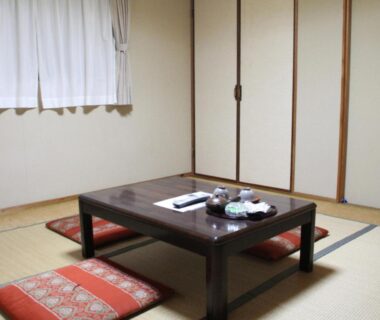 Traditional tatami room with low wooden table and floor cushions at Kannawaso, Ōita, Kyūshū, Japan