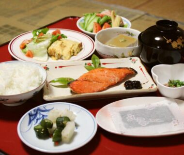 Grilled salmon, rice, miso soup and pickles on a lacquer tray at Kannawaso in Ōita