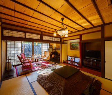 Tatami room with low table, shoji screens and seating area at Kannomori in Ōita, Kyūshū