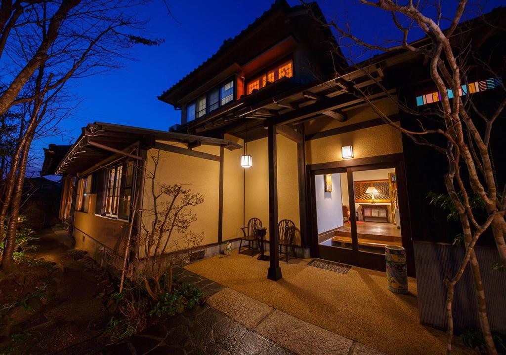 Evening ryokan entrance Kannomori Oita Kyushu Lit traditional ryokan entrance with wooden beams and shoji doorway at Kannomori Oita Kyushu