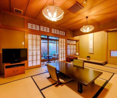 Traditional tatami room with low table and shoji screens at Kappo Ryokan Yumesaki in Oita, Kyushu