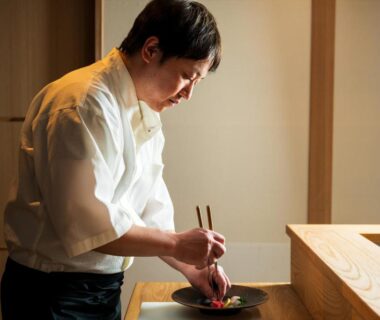 Chef plating a dish at the counter in Kappo Ryokan Yumesaki, Ōita, Kyushu, Japan