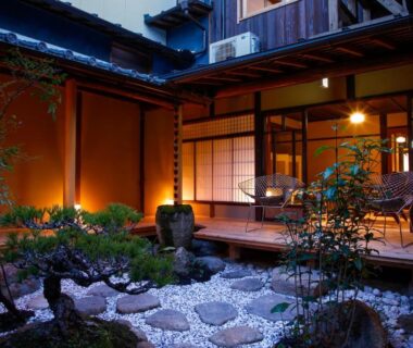 Stone path and raked gravel garden with engawa veranda and shoji screens at Kariya Ryokan Q in Hyōgo Kansai