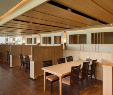 Partitioned wooden dining area with tables and chairs at Kashikojima Hojoen Mie