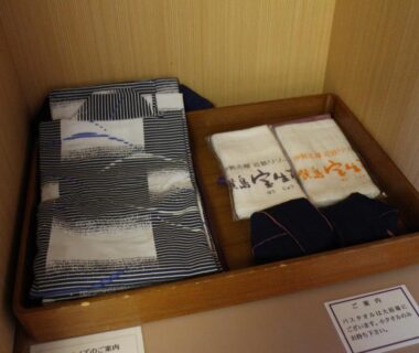 Folded yukata and towels in wooden tray at Kashikojima Hojoen ryokan, Mie prefecture