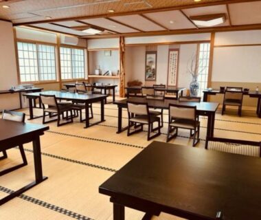 Tatami dining room with low wooden tables and chairs at Kashiwaya Gassan in Yamagata