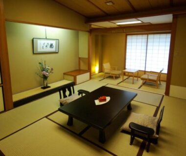 Traditional tatami room with low table, shoji screens and tokonoma at Kasuga Hotel Nara