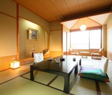 Traditional tatami room with low table, zabuton cushions and shoji screens at Kasuitei Ooya in Yamanashi