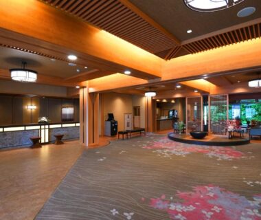 Spacious lobby with wooden beams, reception counter and garden view at Kasuitei Ooya, Chūbu, Yamanashi