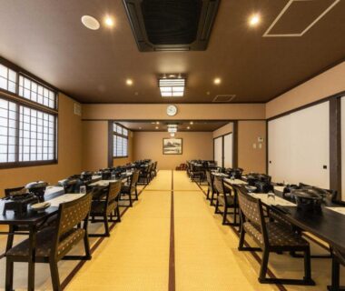 Tatami dining hall with low tables, chairs and shoji screens at Katsuragi Onsen, Wakayama, Kansai