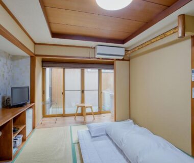 Tatami room with futon bedding and sliding doors at Katsuzakikan, Chūbu, Ishikawa, Japan