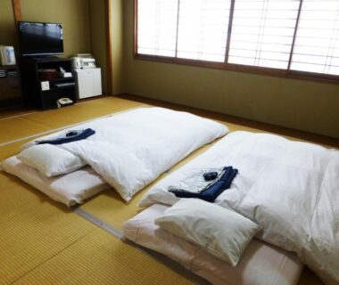 Two futons on tatami floor beside shoji window at Kawaguchiko Lakeside Hotel Yamanashi