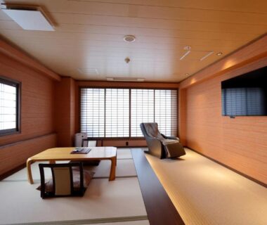 Tatami room with low table, shoji screens and TV at Kawaguchiya Kinosaki Riverside Hotel, Hyōgo, Kansai