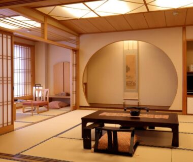 Tatami mat room with low table and shoji screens at Kawaguchiya Kinosaki Riverside Hotel Hyōgo