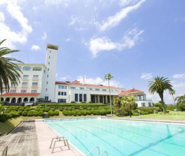 Outdoor pool and palm trees in front of Kawana Hotel in Shizuoka, Chūbu