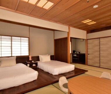 Twin beds on raised wooden platforms in a tatami room at Kawana Hotel, Shizuoka, Chubu, Japan