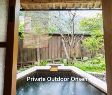 Outdoor onsen bath opening to walled garden through sliding door at Kazeya, Gifu, Chūbu