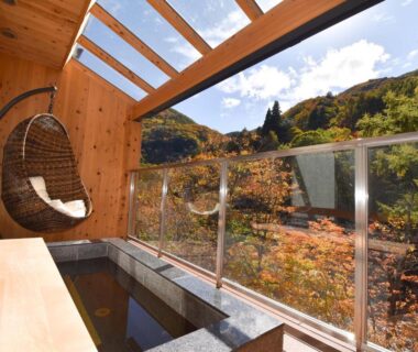Stone soaking tub on balcony with hanging wicker chair, Keiryuso Siorie, Nagano mountain foliage view