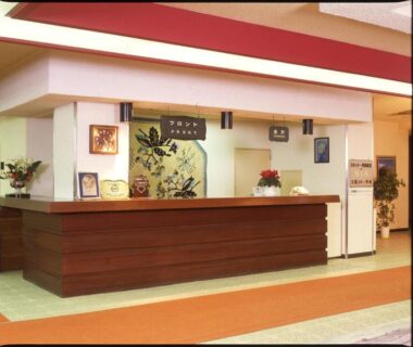 Wooden reception counter at Kidoike Onsen Hotel lobby in Nagano
