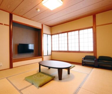 Tatami room with low table, shoji screens and floor cushions at Kii no Matsushima in Mie, Kansai
