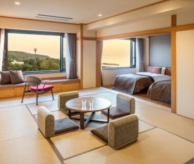 Tatami room with low table, window seating and twin beds at Kiki Shiretoko Natural Resort Hokkaidō
