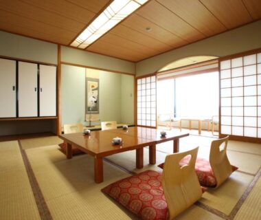 Traditional tatami room with low table, zabuton cushions, shoji screens and tokonoma at Kikuchi Kanko Hotel Kumamoto